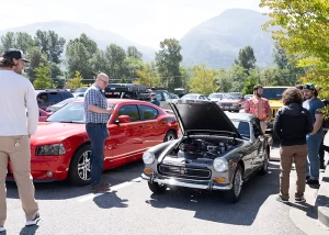 Employees looking at antique car