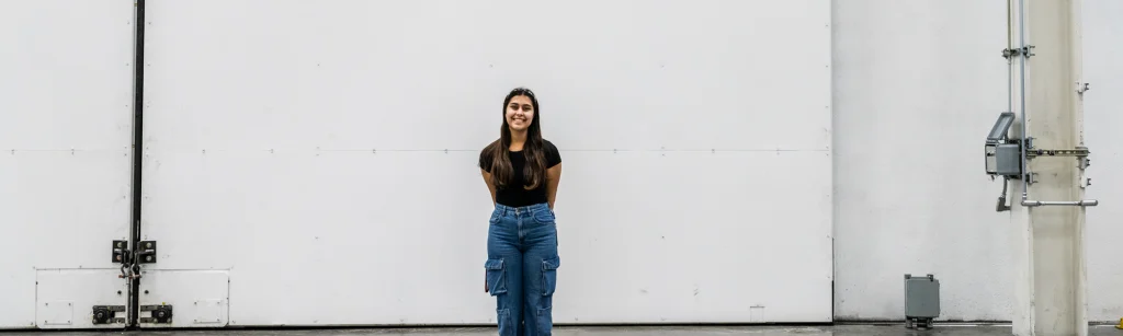 Eve in front of white wall