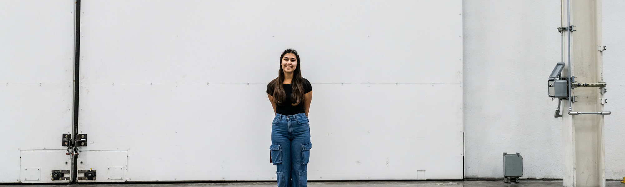 Eve in front of white wall