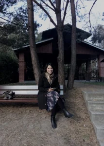 Noemi on a bench in front of a building