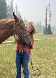 Kenna standing with her horse