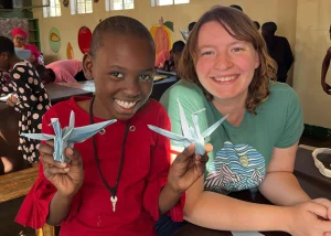 Jessica and a child making paper cranes