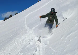 Peter skiing through deep powder snow