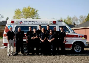 Harmony poses with EMT truck and coworkers