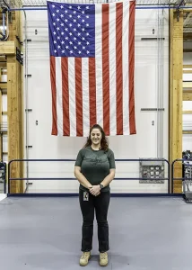 Harmony poses in front of American flag